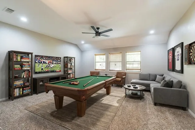 a living room with furniture a projector and a flat screen tv