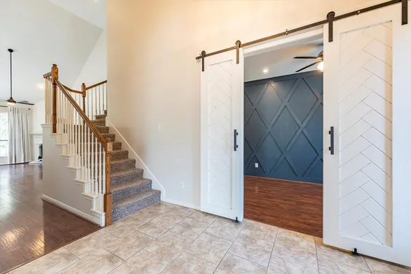 a view of entryway with wooden floor and stairs