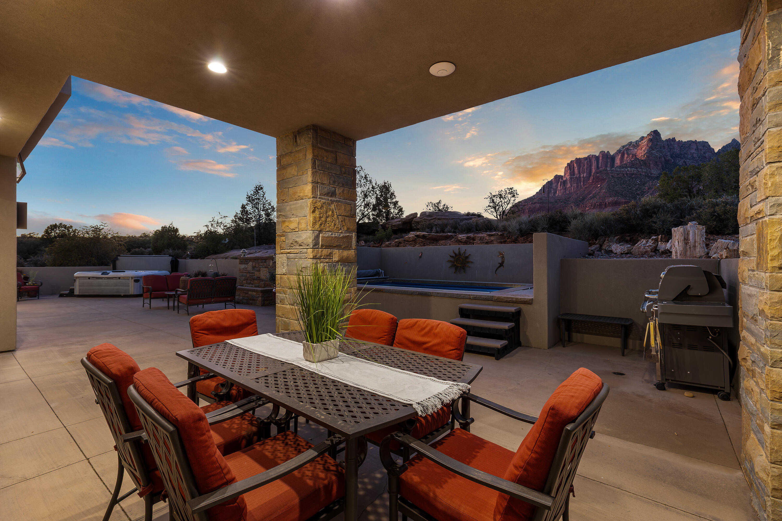 3000 Navajo Way Springdale, UT 84767 - Photo 11 of 63 Covered patio dining area oriented toward the cliffs, shown at twilight with direct sightlines to the surrounding rock formations.