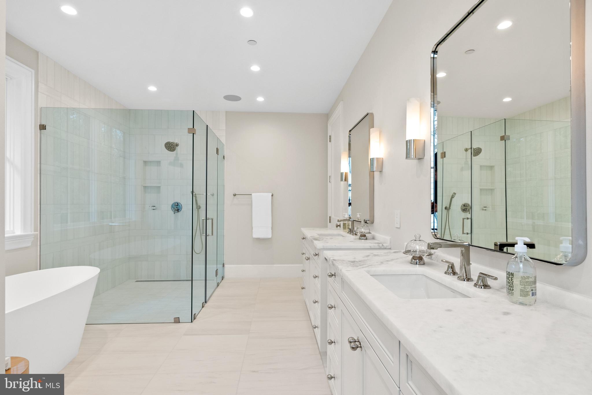 4905 Van Ness Street Northwest Washington, DC 20016 - Photo 18 of 27 a bathroom with a double vanity sink mirror and shower