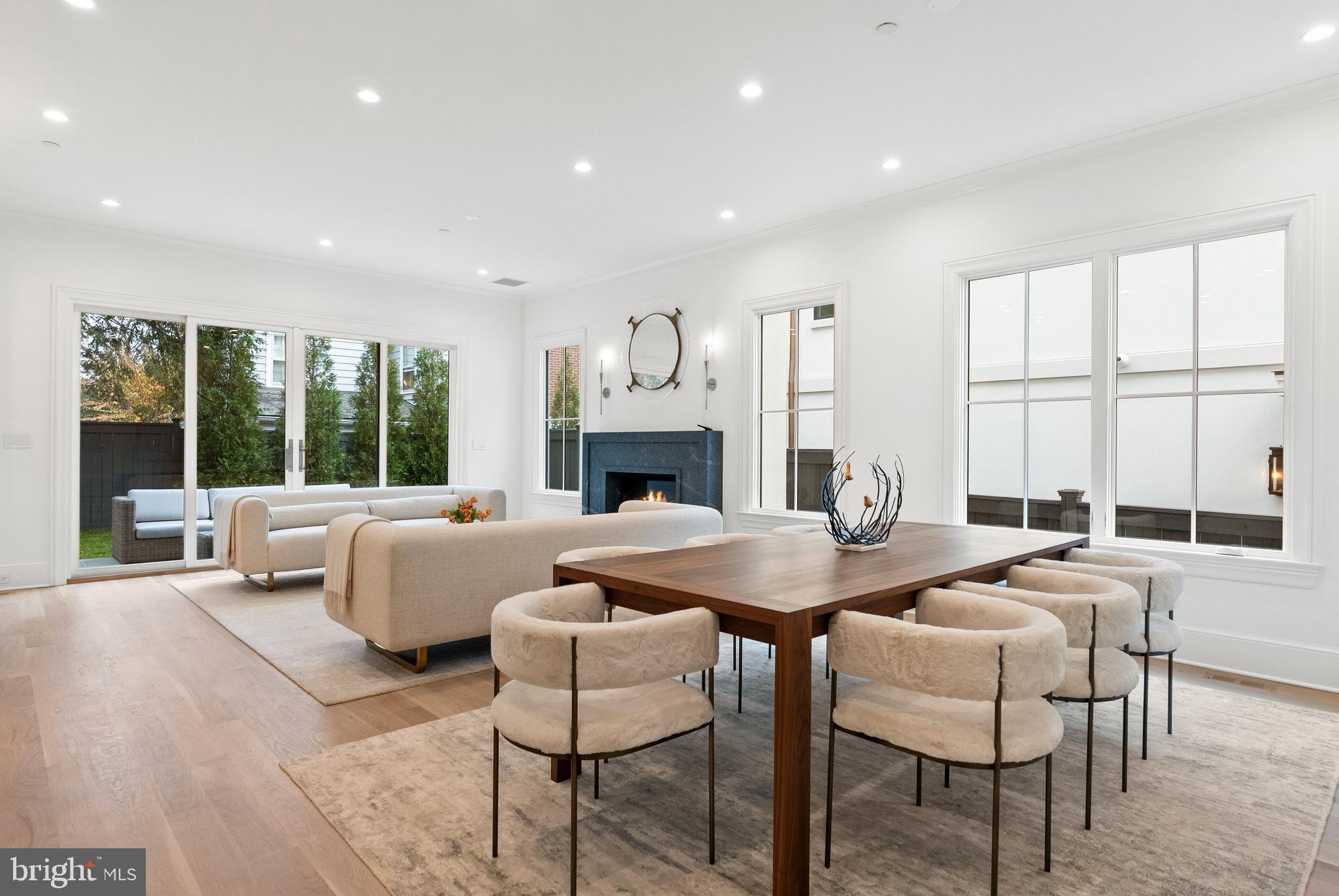 4905 Van Ness Street Northwest Washington, DC 20016 - Photo 10 of 27 a dining room with furniture a fireplace and wooden floor