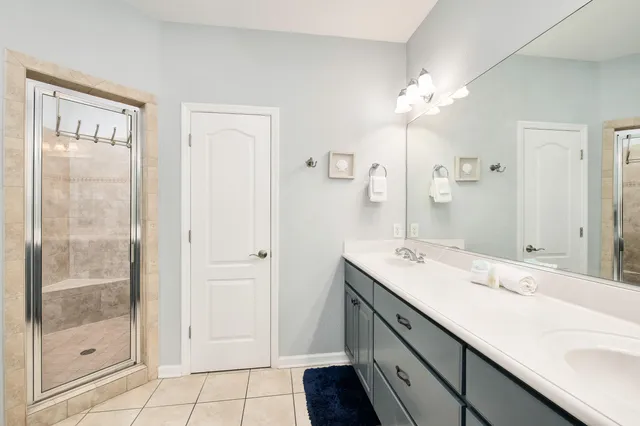 a spacious bathroom with a tub sink and mirror