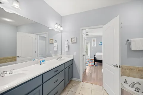 a bath tub sitting next to a white sink