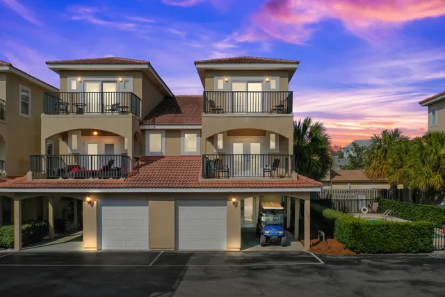 an aerial view of residential houses with outdoor space and ocean view