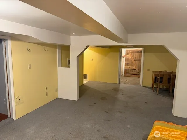 a view of a livingroom with furniture and a hallway