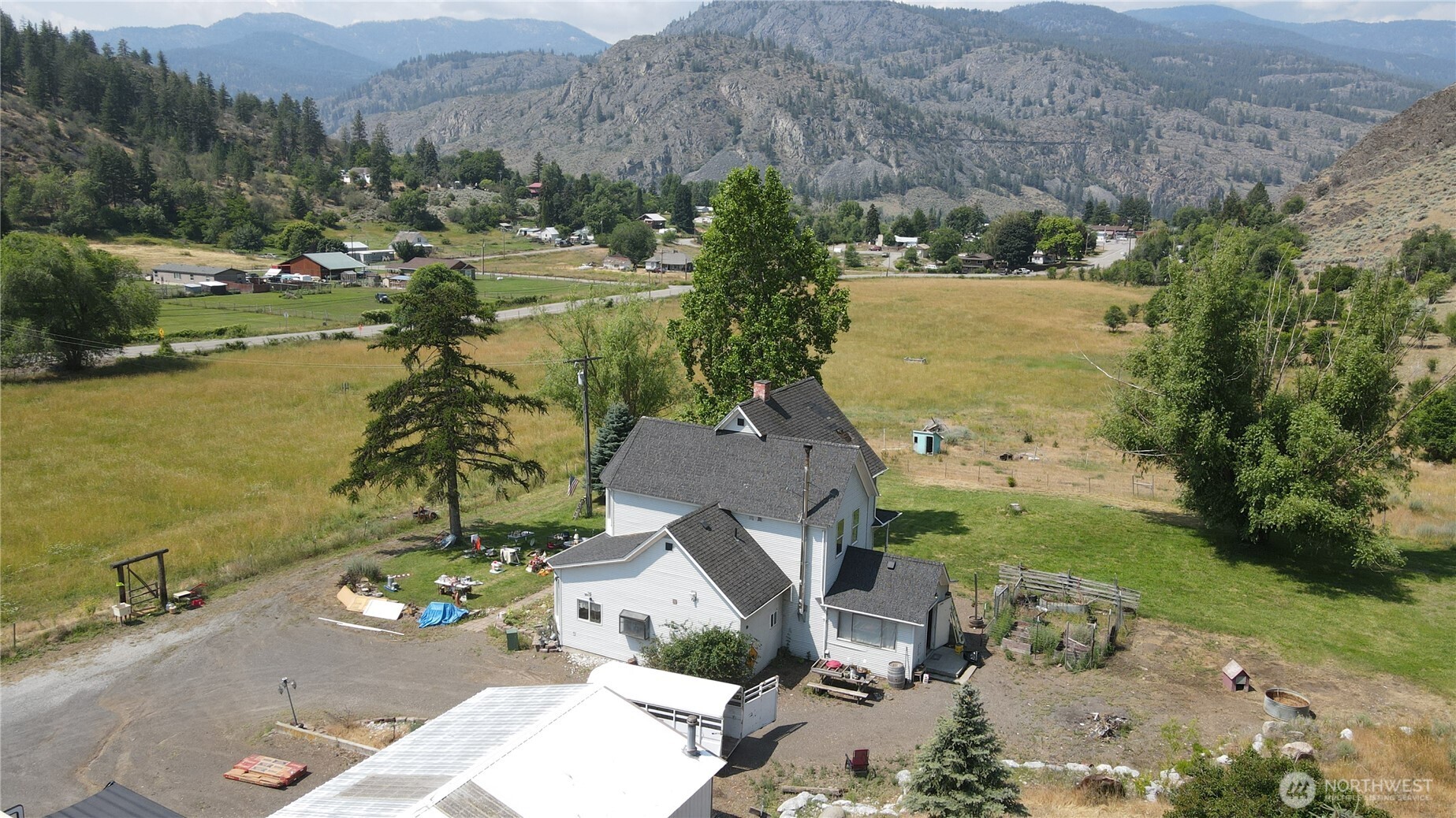 1112 Loomis-Oroville Road Loomis, WA 98827 - Photo 33 of 40 an aerial view of a house with garden space and mountain view in back