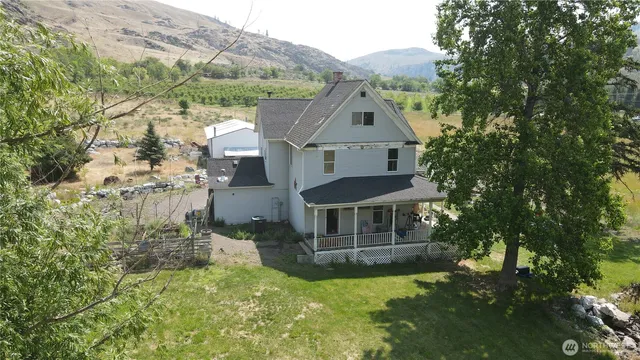 a aerial view of a house with a yard table and chairs