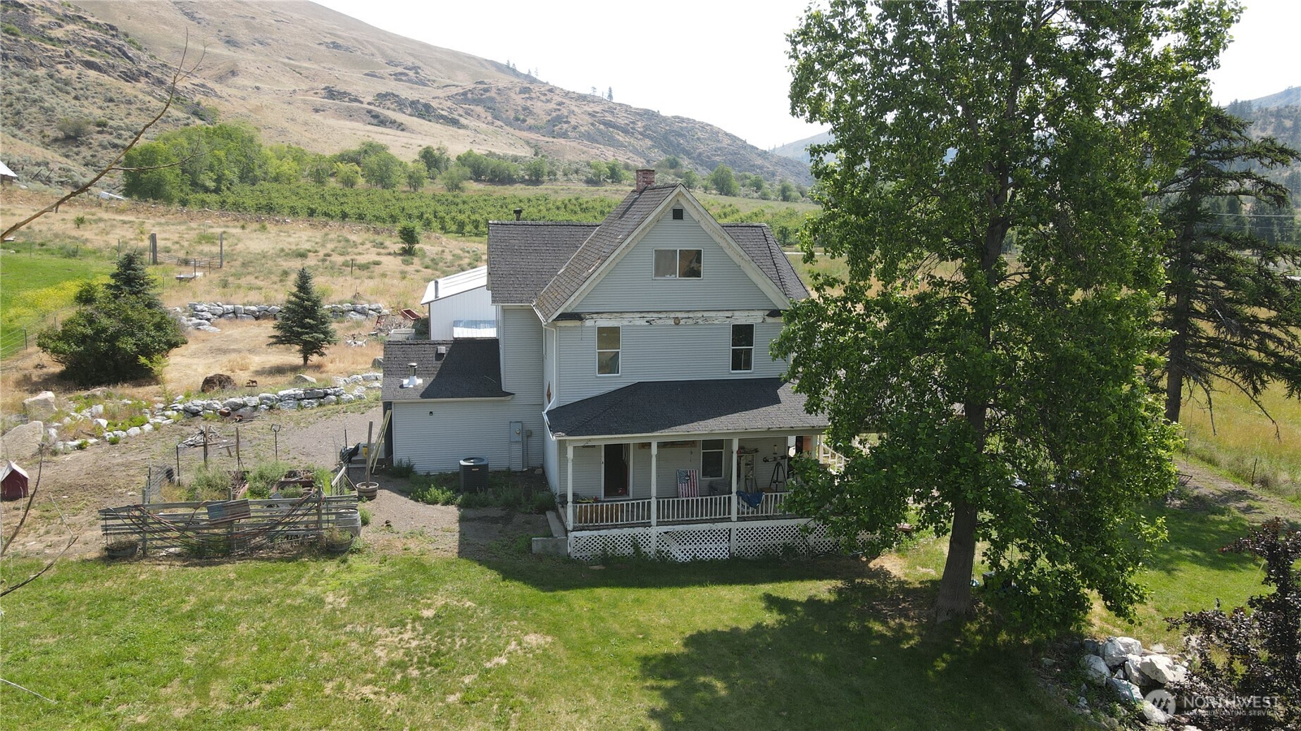 1112 Loomis-Oroville Road Loomis, WA 98827 - Photo 38 of 40 a aerial view of a house with a yard table and chairs
