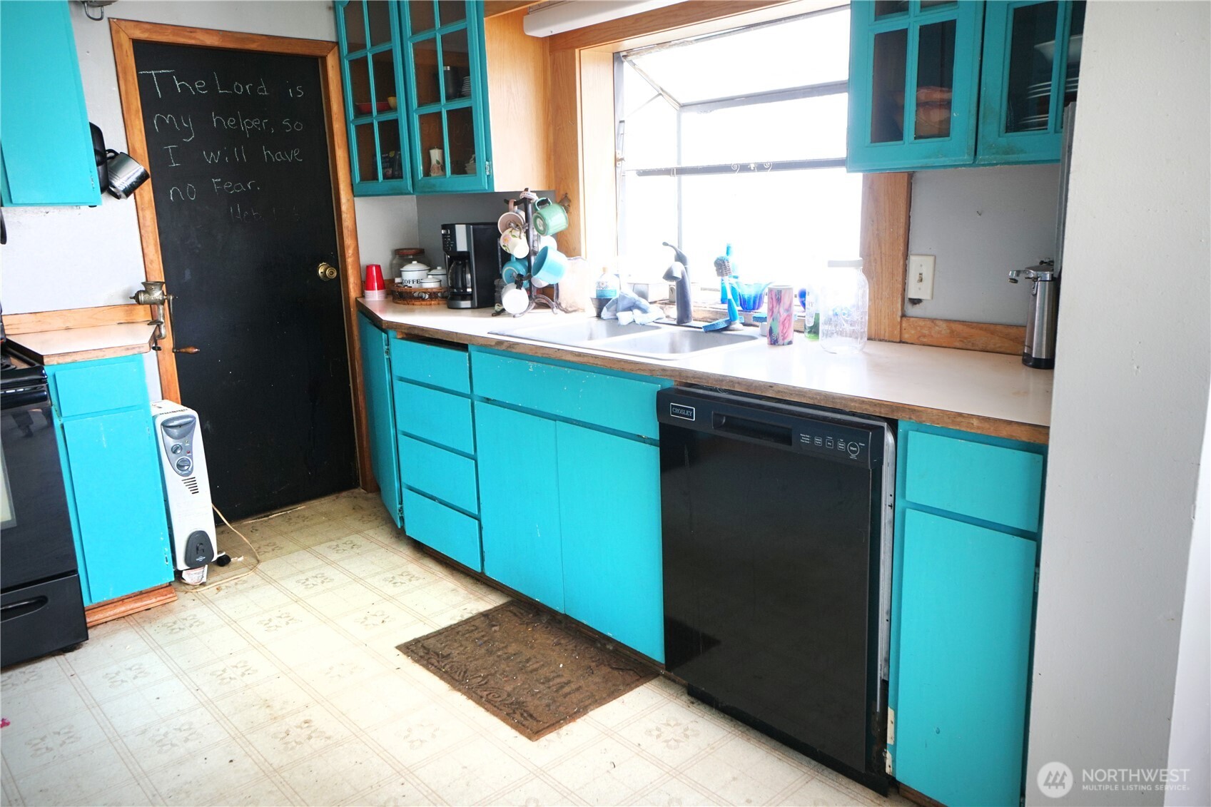 1112 Loomis-Oroville Road Loomis, WA 98827 - Photo 8 of 40 a kitchen with a sink window and cabinets