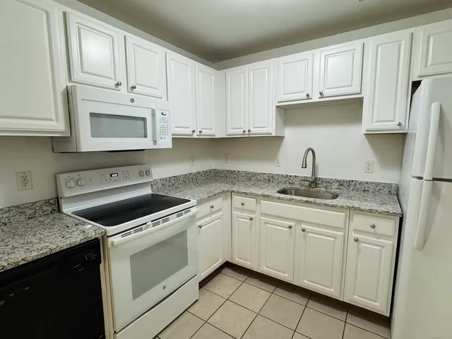 a kitchen with cabinets appliances and a sink