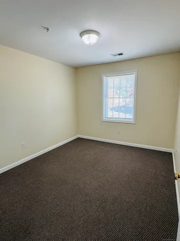 an empty room with a empty space and windows