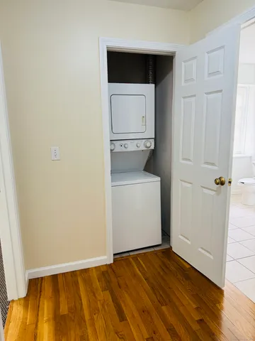 a view of a room with wooden floor and cabinet