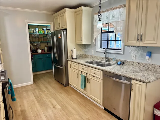 a kitchen with stainless steel appliances granite countertop a refrigerator and a sink