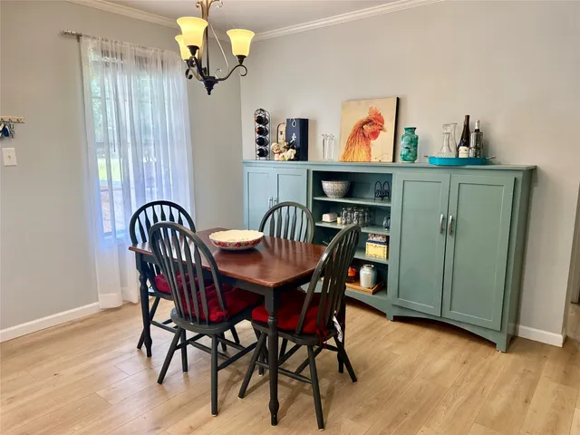 a view of a dining room with furniture wooden floor and a chandelier