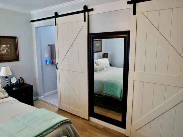 a bedroom with a bed and a mirror