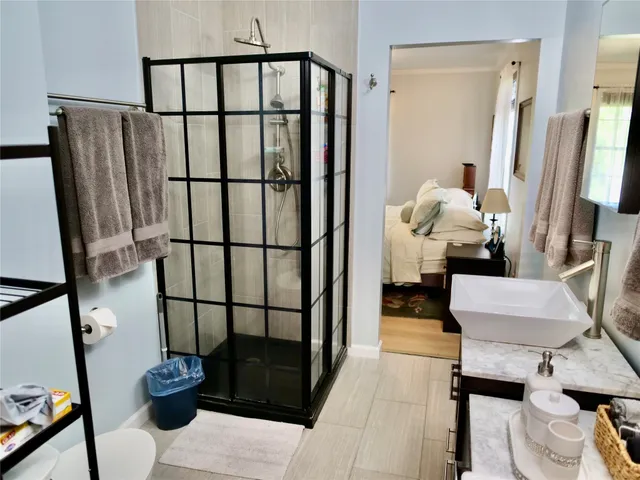 a bathroom with a sink a toilet and a shower