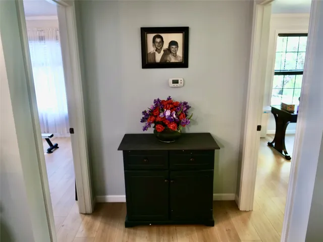 a view of a hallway with workspace and mirror