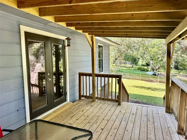 a backyard of a house with yard table and chairs