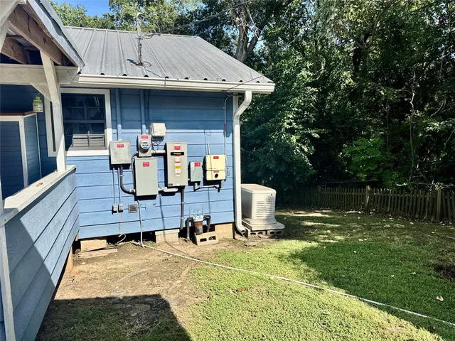 a view of a patio with table and chairs a barbeque with wooden fence