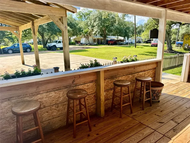 a view of a swimming pool with a table and chairs next to a yard