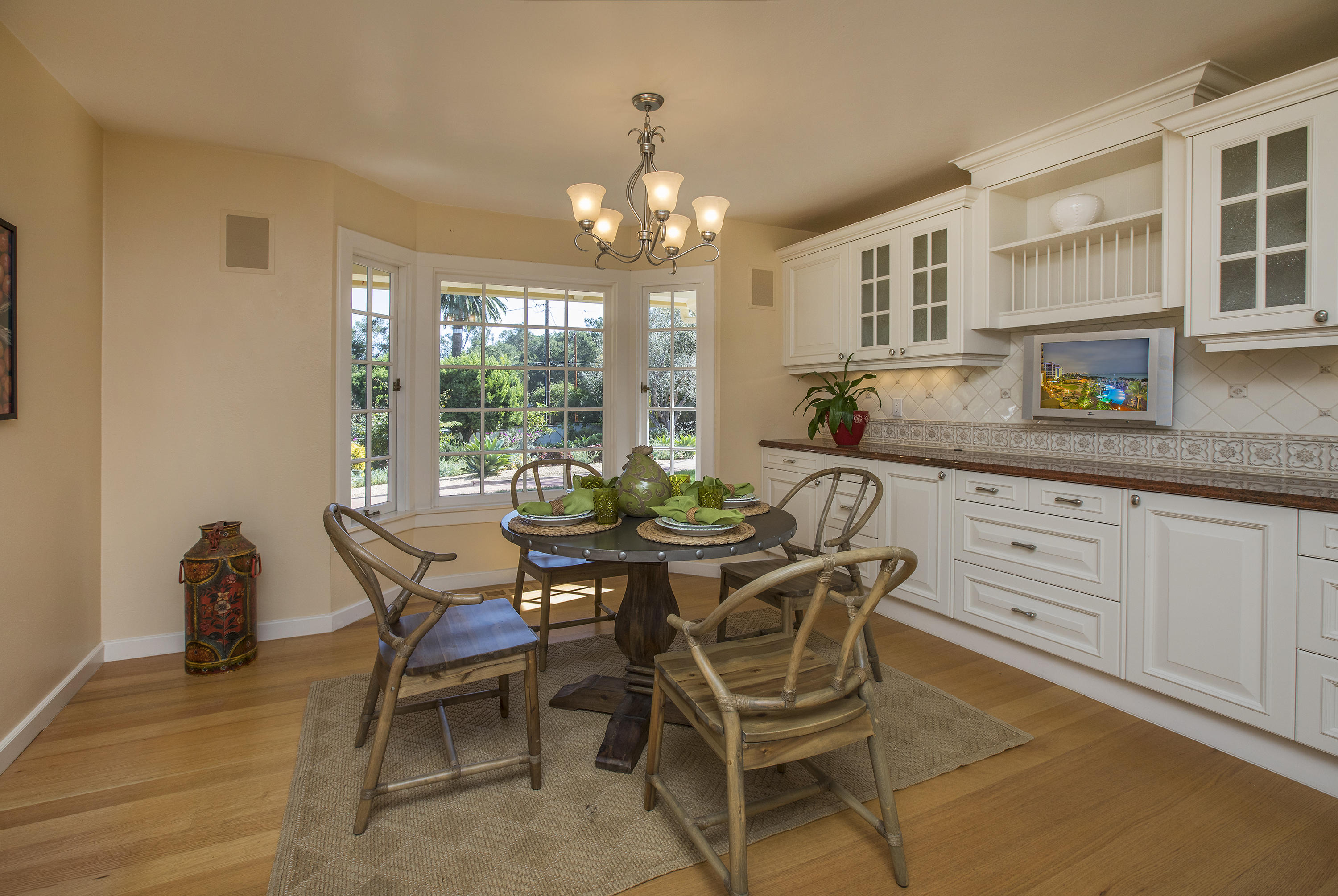 3165 Eucalyptus Hill Road Santa Barbara, CA 93108 - Photo 8 of 21 a dining room with furniture a chandelier and wooden floor