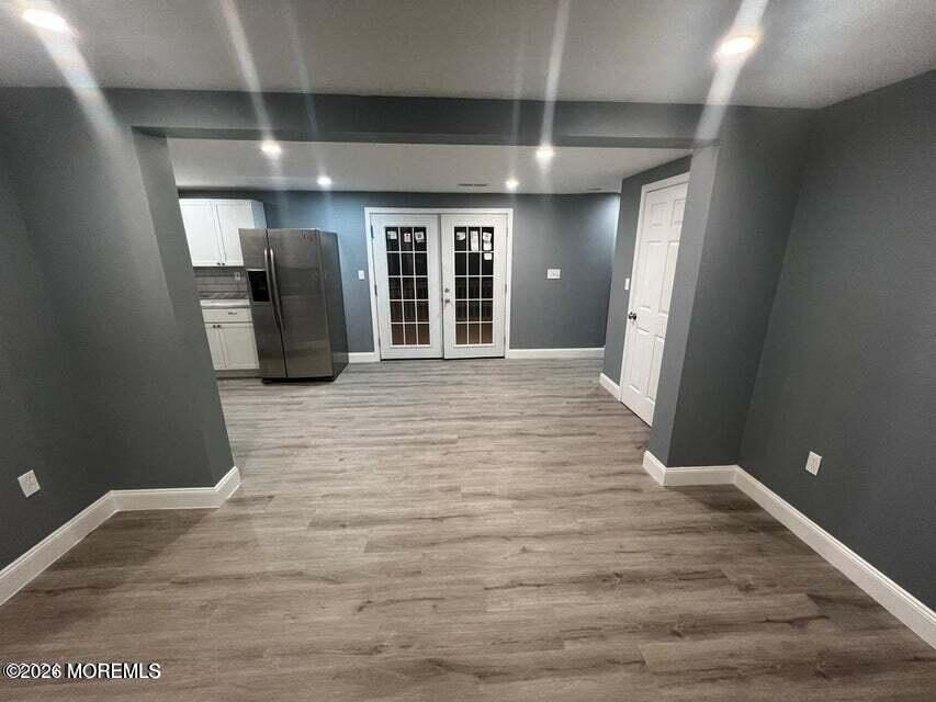 6611 Magnolia Drive Millville, NJ 08332 - Photo 6 of 14 a view of a hallway with wooden floor and a kitchen