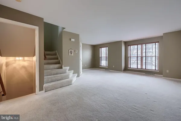a view of an empty room with a fireplace