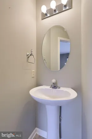 a bathroom with a sink a mirror and vanity