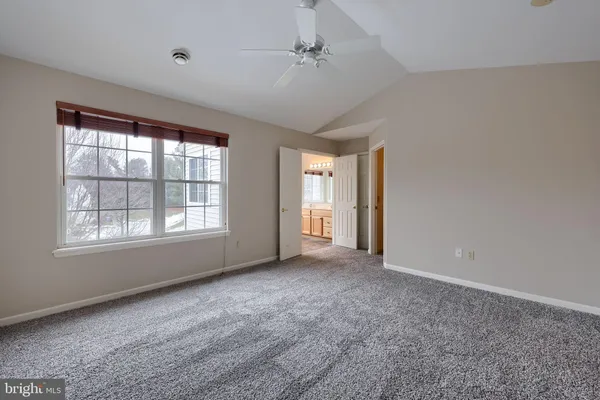 an empty room with windows and closet