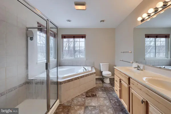 a bathroom with a tub sink toilet and a shower