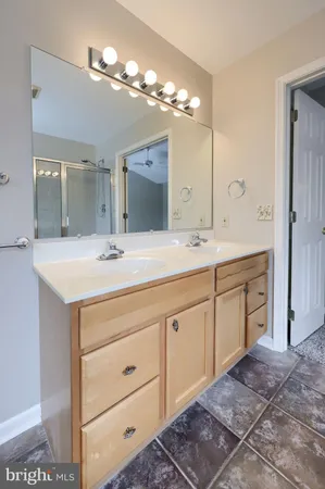 a bathroom with a sink vanity and a mirror
