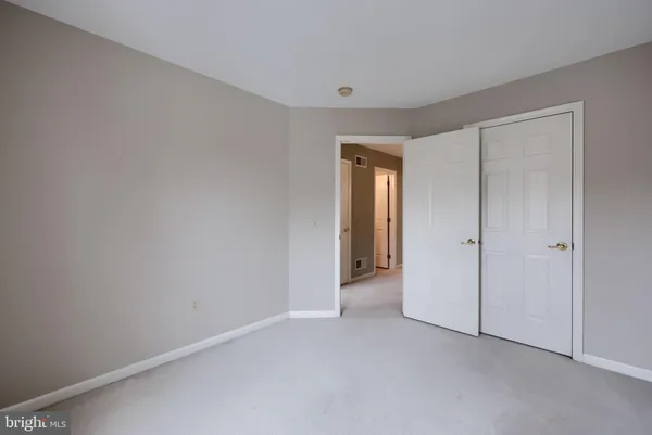 a view of an empty room and closet area