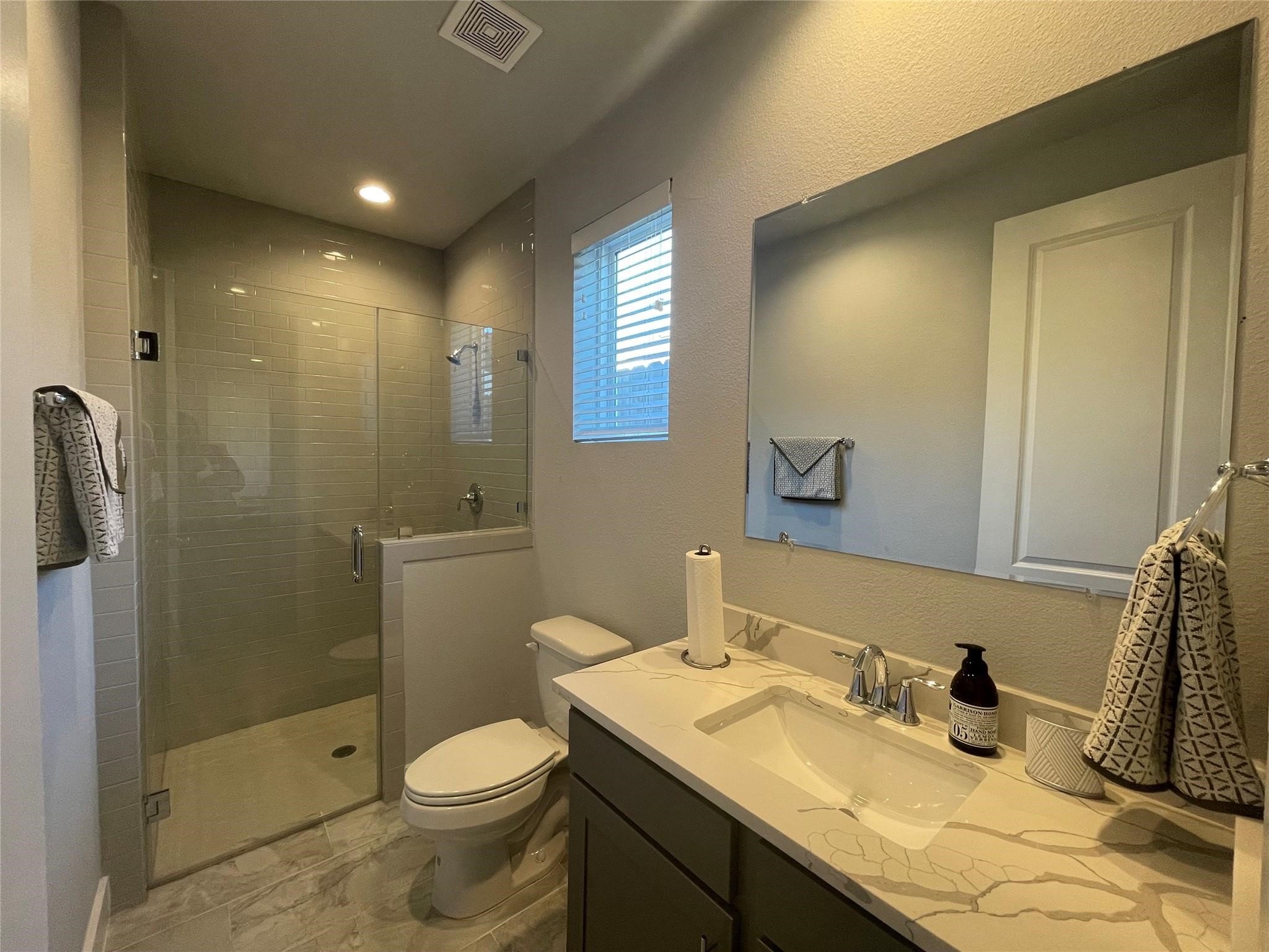 902 Martin Street, Unit A Houston, TX 77018 - Photo 14 of 21 a bathroom with a granite countertop sink toilet and shower