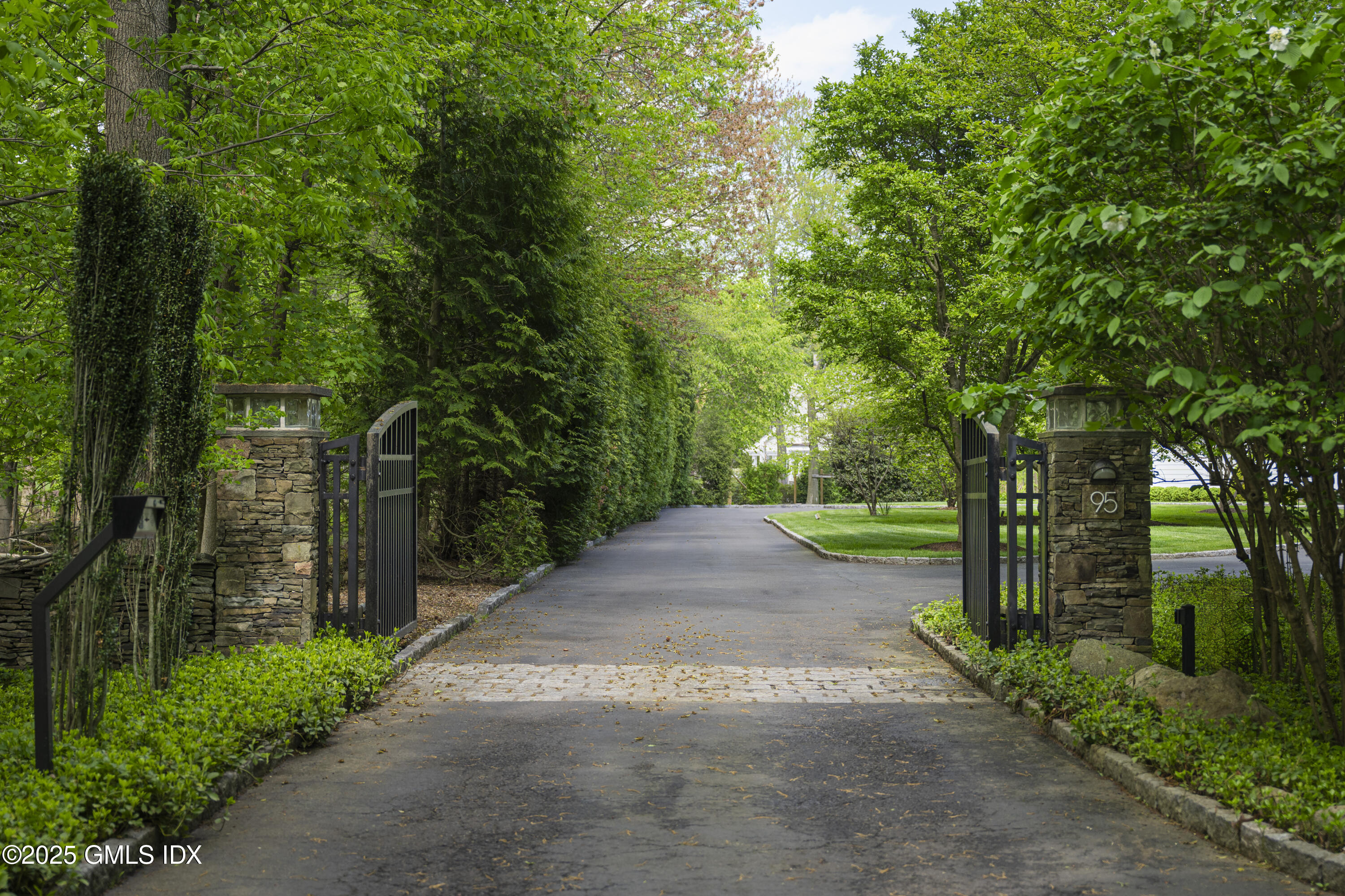 95 Indian Head Road Riverside, CT 06878 - Photo 2 of 10 a view of a street with trees on both side of it