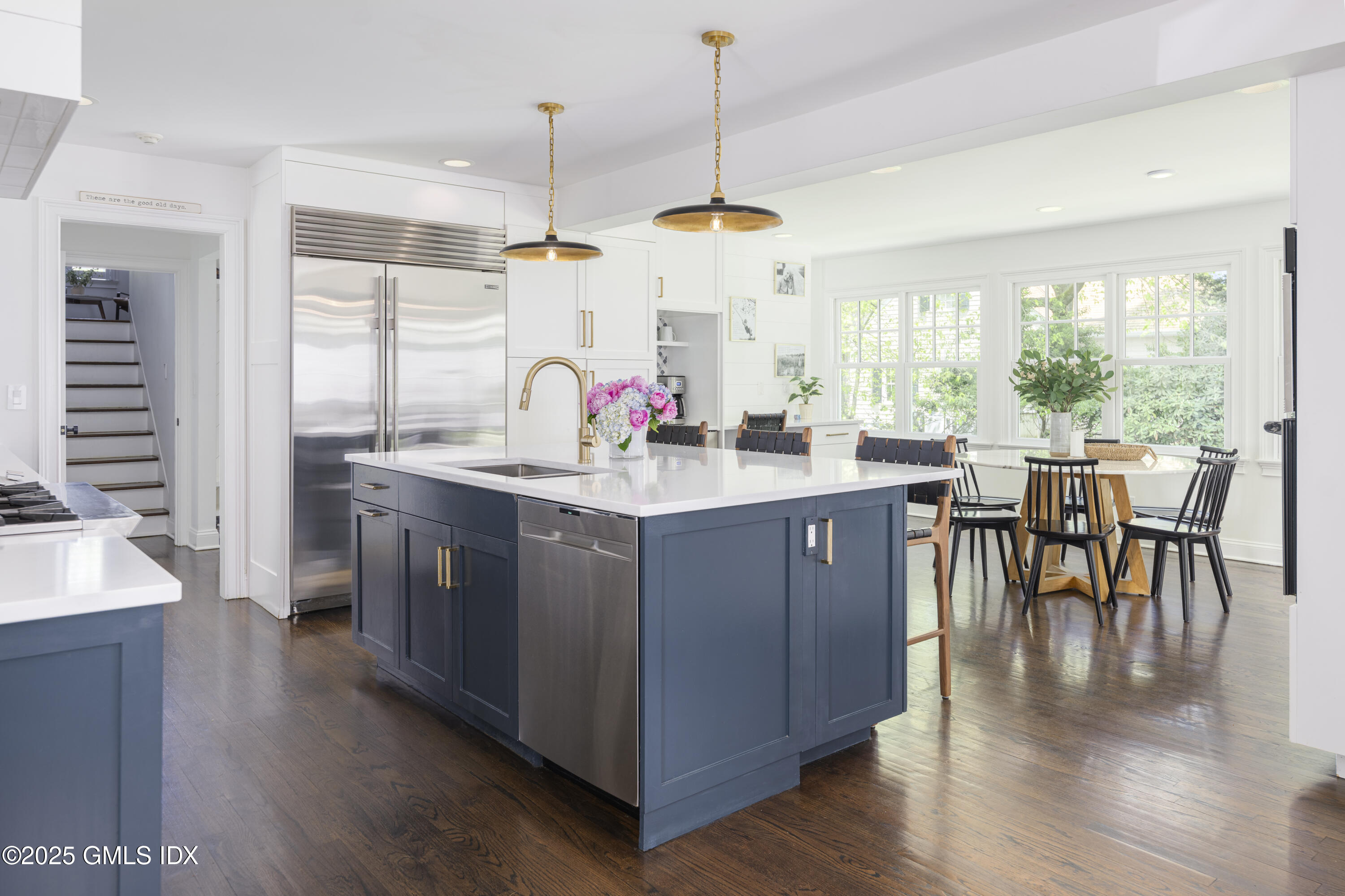 95 Indian Head Road Riverside, CT 06878 - Photo 4 of 10 a kitchen with a stove a sink a dining table and chairs