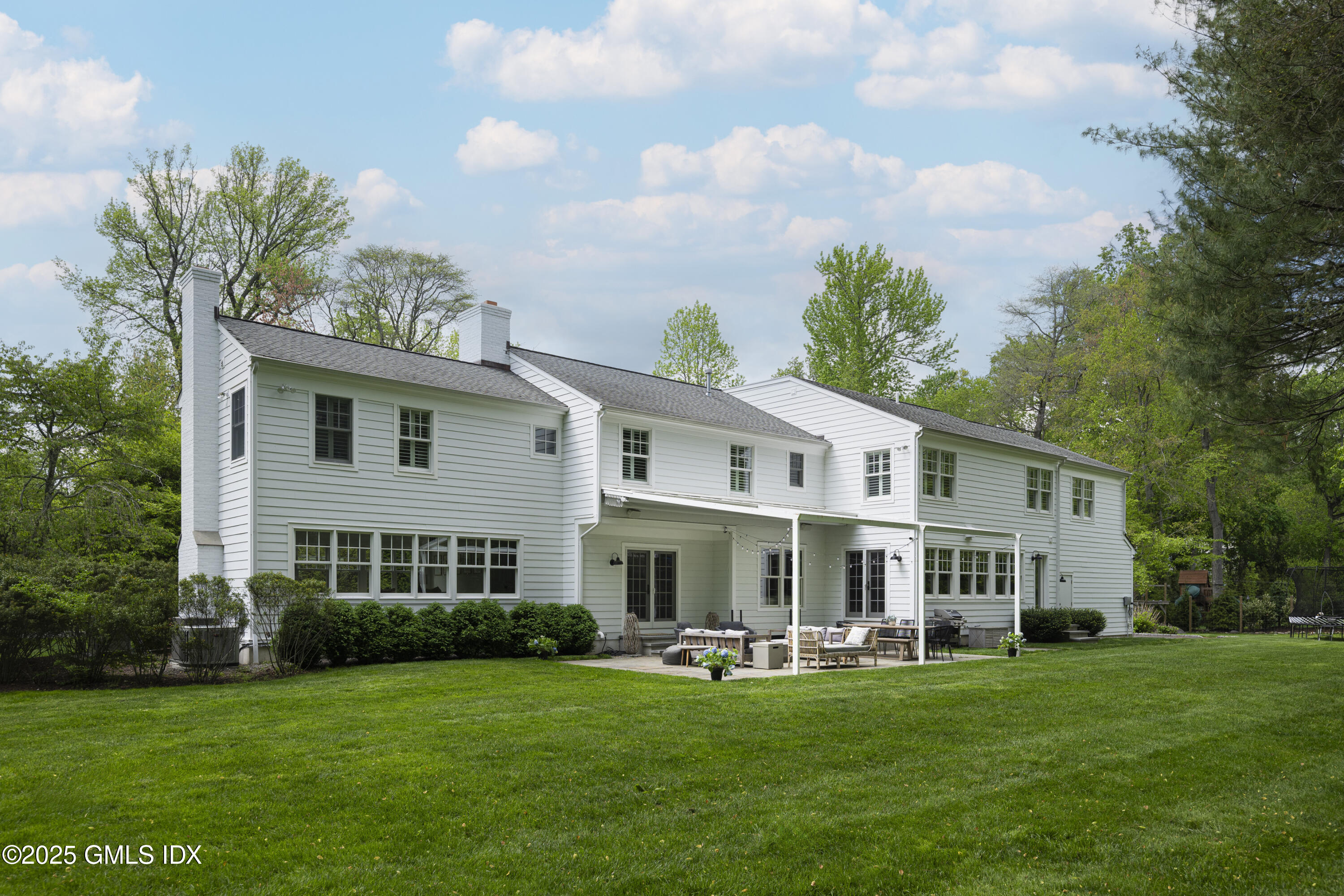 95 Indian Head Road Riverside, CT 06878 - Photo 8 of 10 a front view of a house with a garden and trees