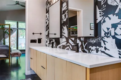 a kitchen with stainless steel appliances sinks a counter top space and a large window