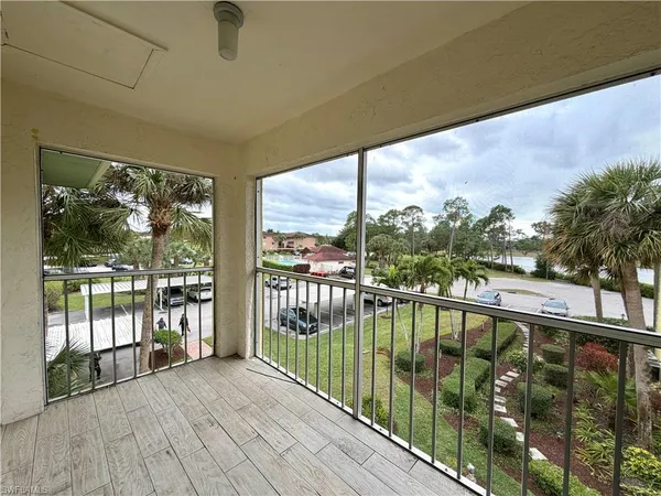 a view of balcony with floor to ceiling windows with wooden floor