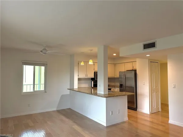a kitchen with a refrigerator and a stove top oven