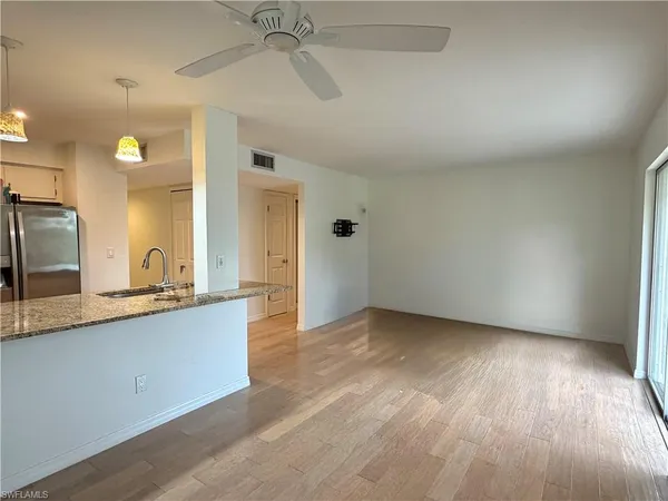 a view of a kitchen with a sink and a large mirror