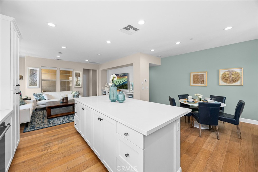 843 Orchid Way, Unit D Azusa, CA 91702 - Photo 11 of 38 a large white kitchen with stainless steel appliances a stove a table and chairs