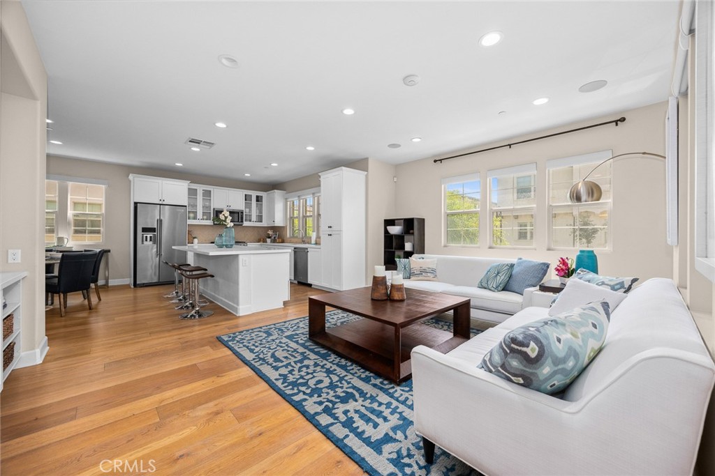 843 Orchid Way, Unit D Azusa, CA 91702 - Photo 13 of 38 a living room with couches and kitchen view with wooden floor