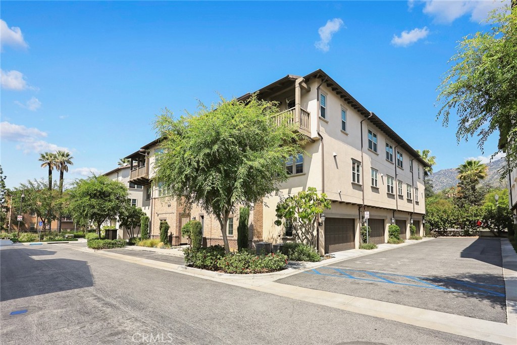 843 Orchid Way, Unit D Azusa, CA 91702 - Photo 2 of 38 a front view of a house with a yard and garage