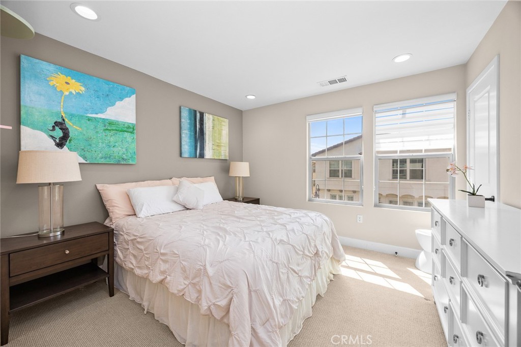 843 Orchid Way, Unit D Azusa, CA 91702 - Photo 24 of 38 a spacious bedroom with a large bed and a large window