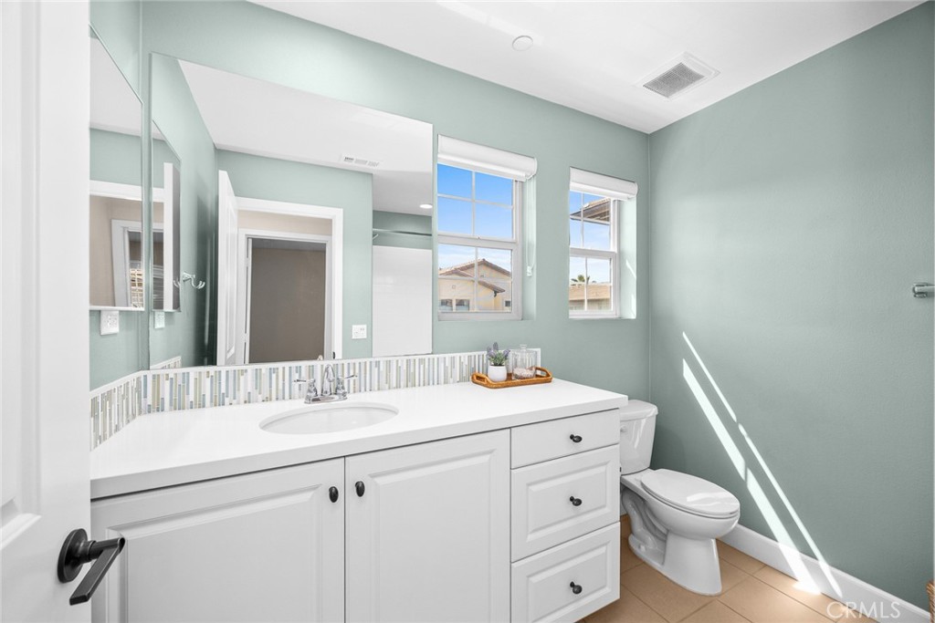 843 Orchid Way, Unit D Azusa, CA 91702 - Photo 25 of 38 a bathroom with a toilet a sink a mirror and a faucet