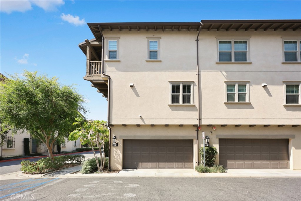 843 Orchid Way, Unit D Azusa, CA 91702 - Photo 28 of 38 a front view of a house with a yard and garage