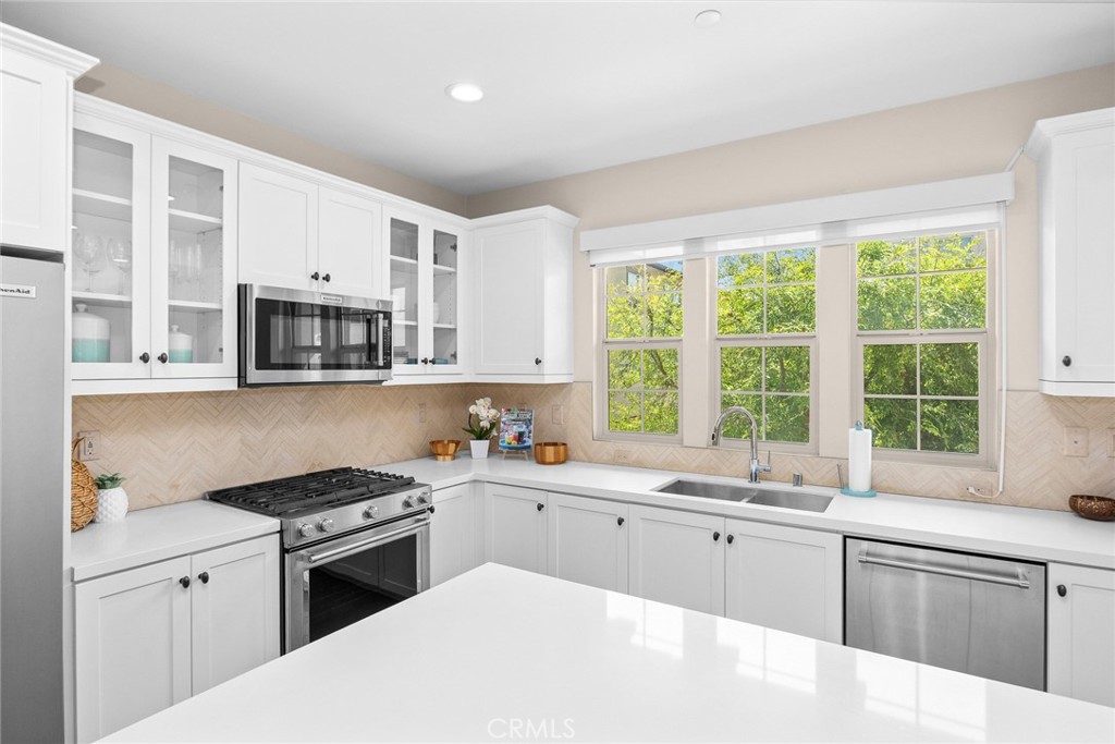 843 Orchid Way, Unit D Azusa, CA 91702 - Photo 10 of 38 a kitchen with granite countertop a sink a window stainless steel appliances and cabinets