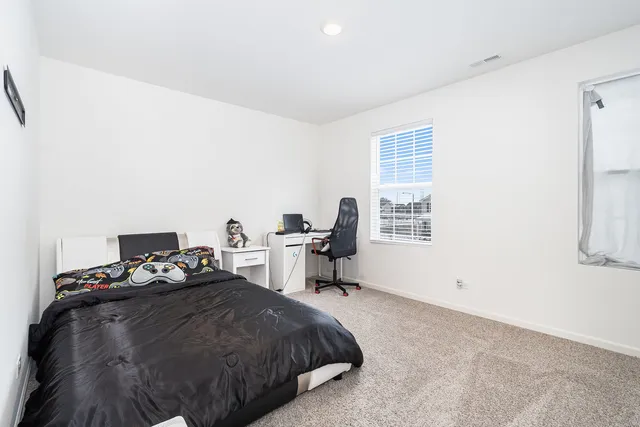 a bedroom with a bed and a window