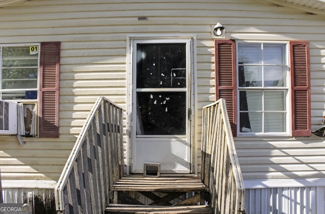 4402 Harper Road Metter, GA 30439 - Photo 2 of 19 a view of a balcony with door and wooden floor