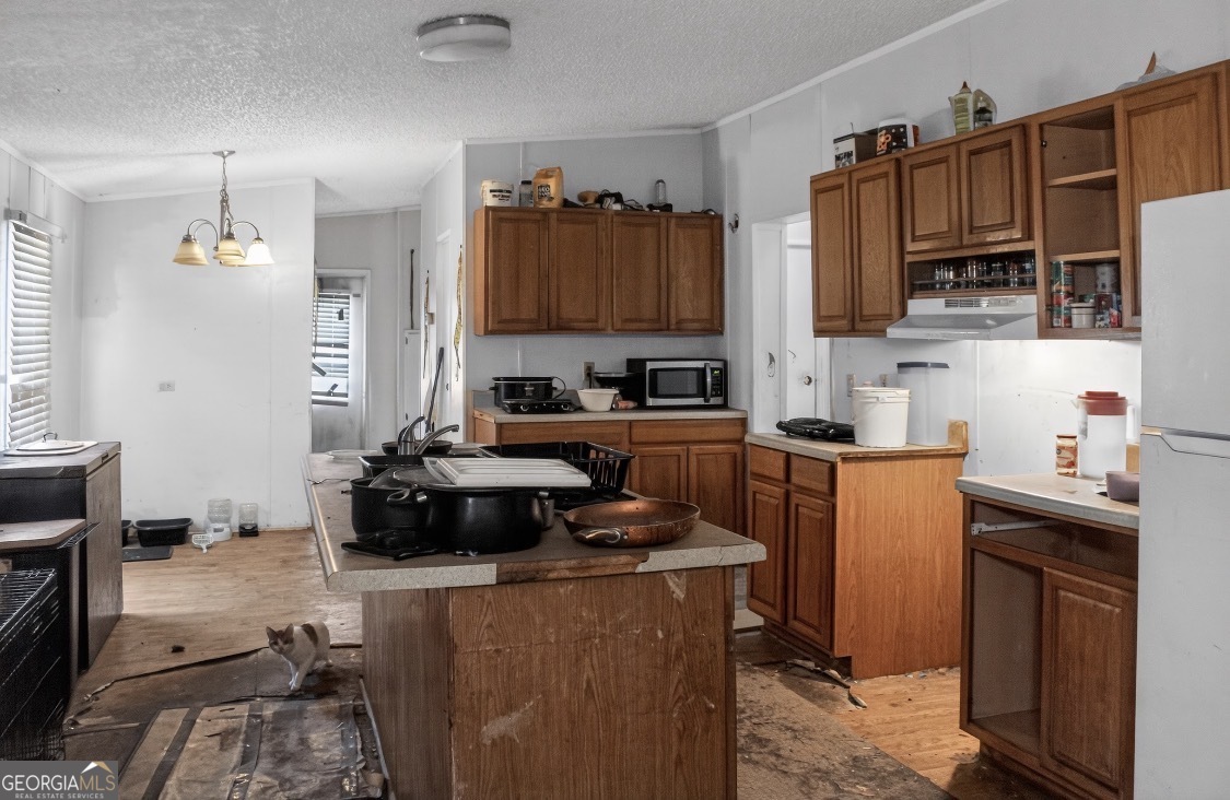 4402 Harper Road Metter, GA 30439 - Photo 8 of 19 a kitchen with stainless steel appliances a stove a sink dishwasher and a refrigerator with wooden floor